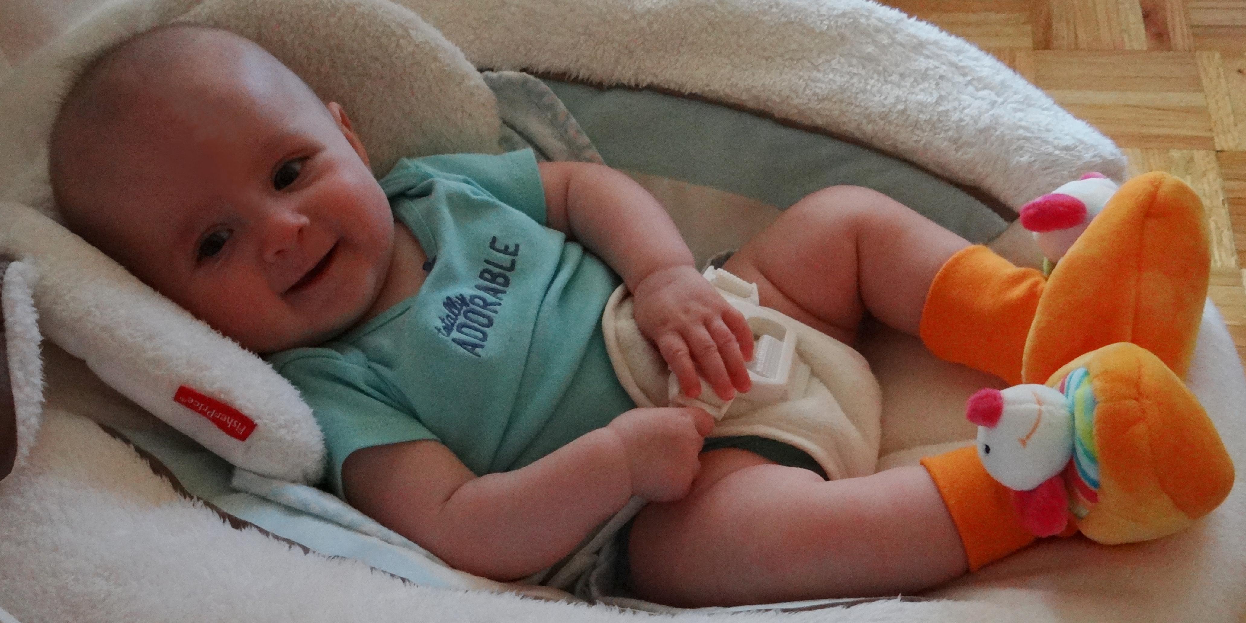 Baby wearing Baby Fehn rattle booties.