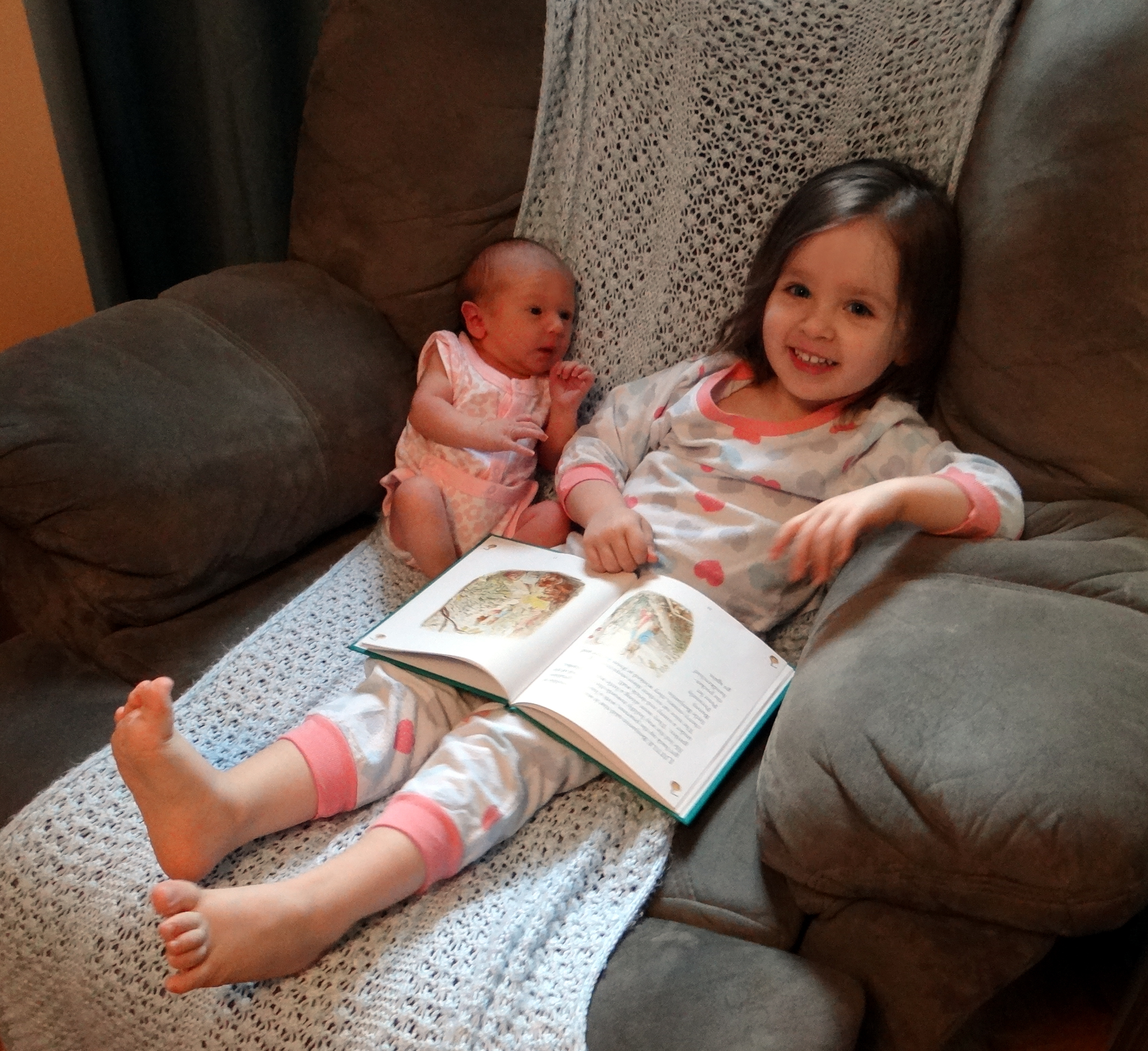 Peachy reading to her baby sister