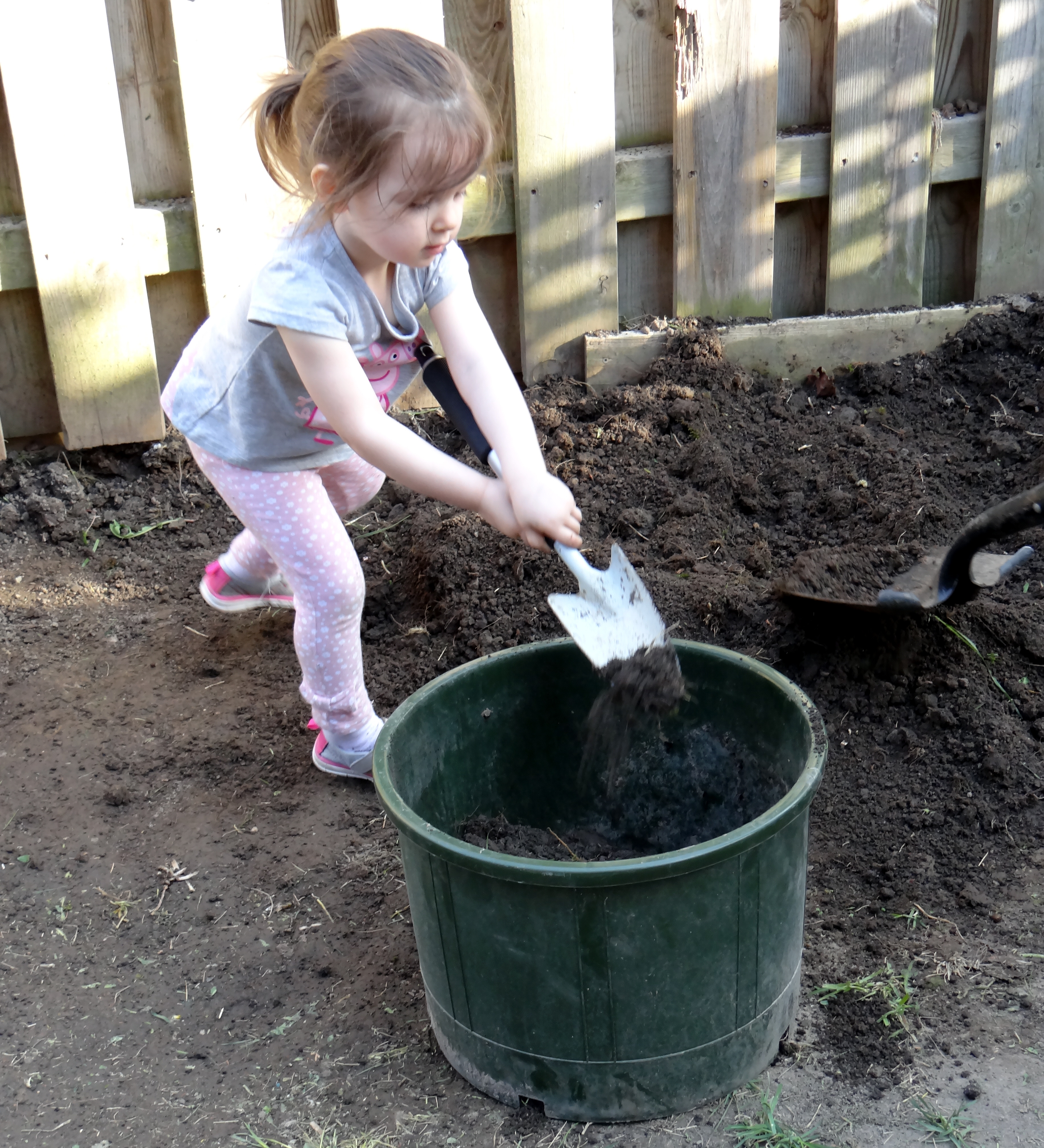 Toddler digging in the yard