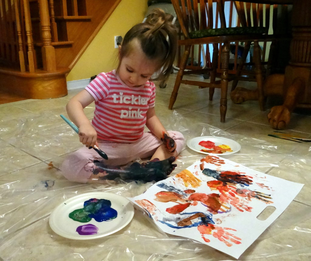 Toddler Peachy painting herself