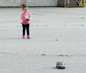 Toddler Peachy at the controls of the remote control car